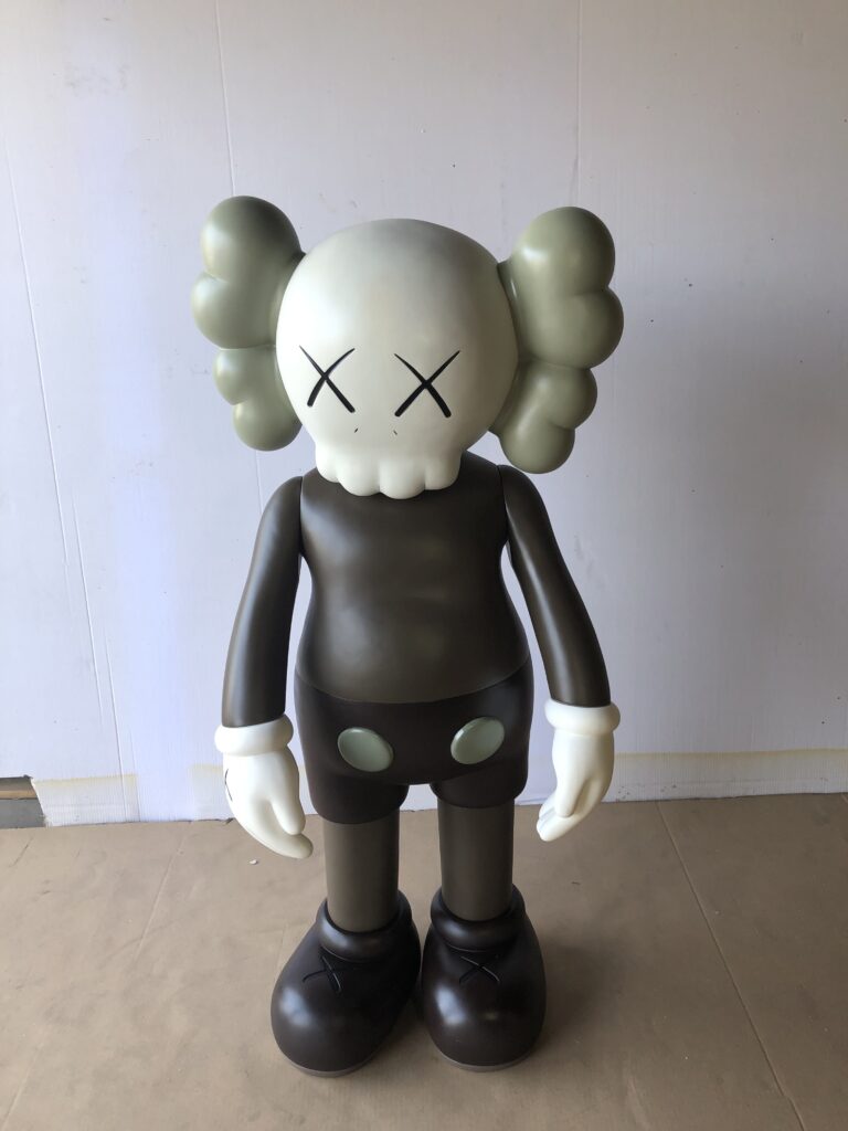 A KAWS Companion figure with a skull-like head, X-ed out eyes, and a brown body.