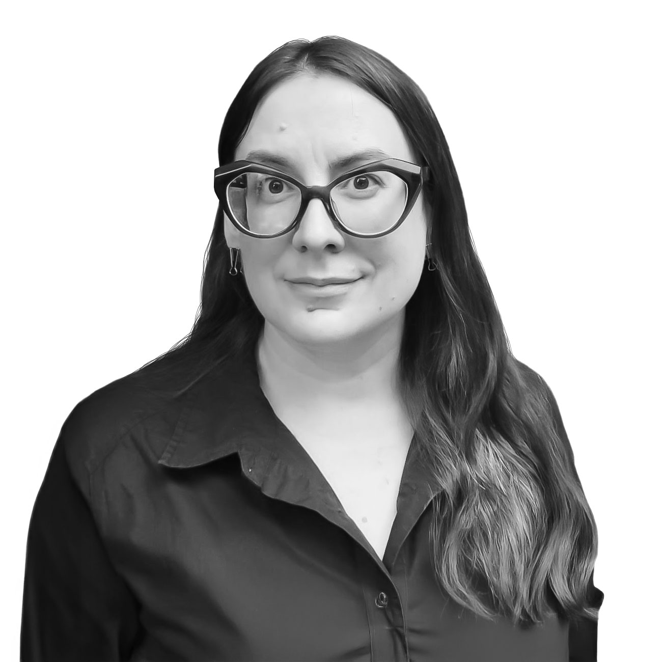 Portrait of a woman with long hair and large glasses, smiling at the camera in a dark collared shirt.