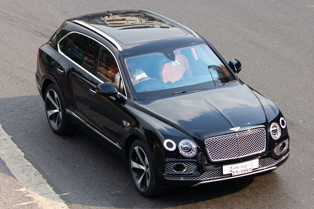 Bentley-bentayga-loan-financing-guide - borro Top-down view of a black luxury suv with a prominent chrome grille parked on a street.