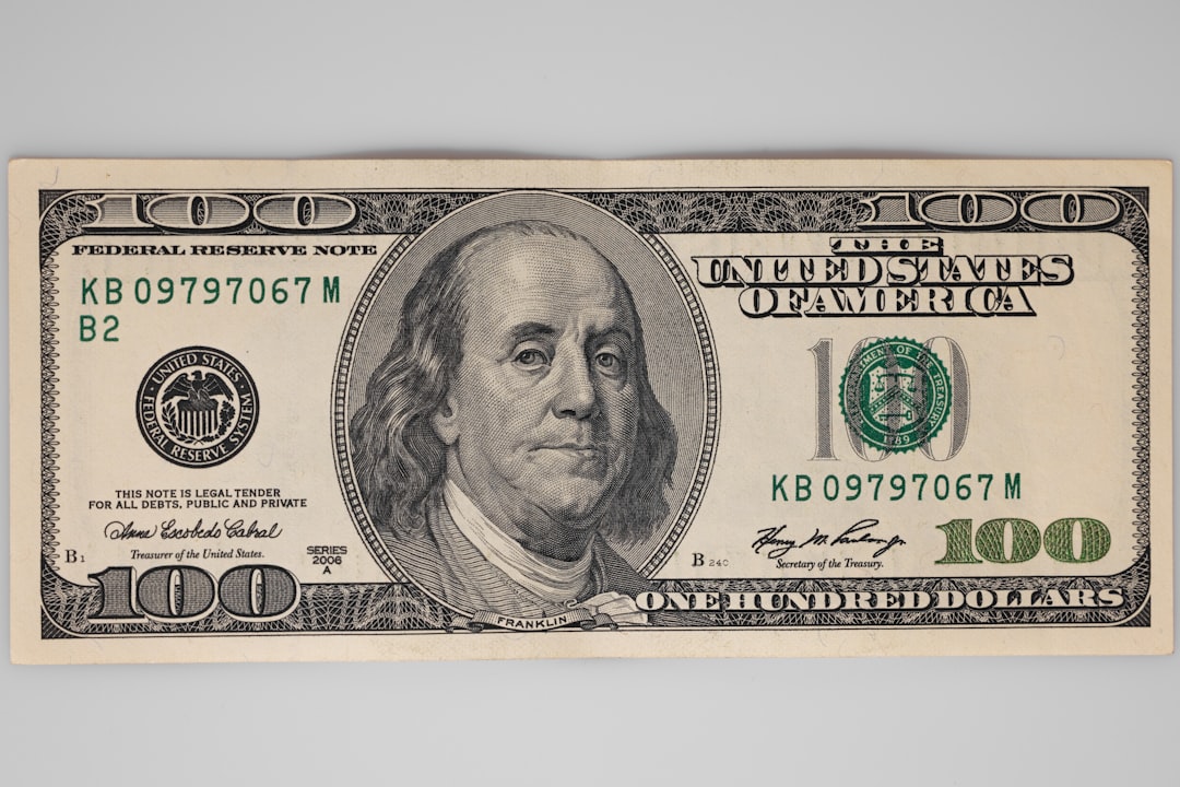 Luxury-asset-loans-black-friday-cyber-monday-liquidity - borro A u. S. One-hundred-dollar bill displaying benjamin franklin's portrait and green serial numbers.