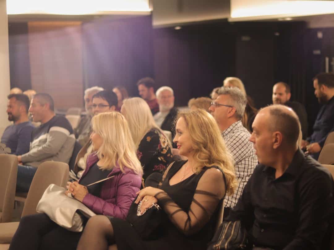 Attentive audience at a business conference in a modern meeting room.