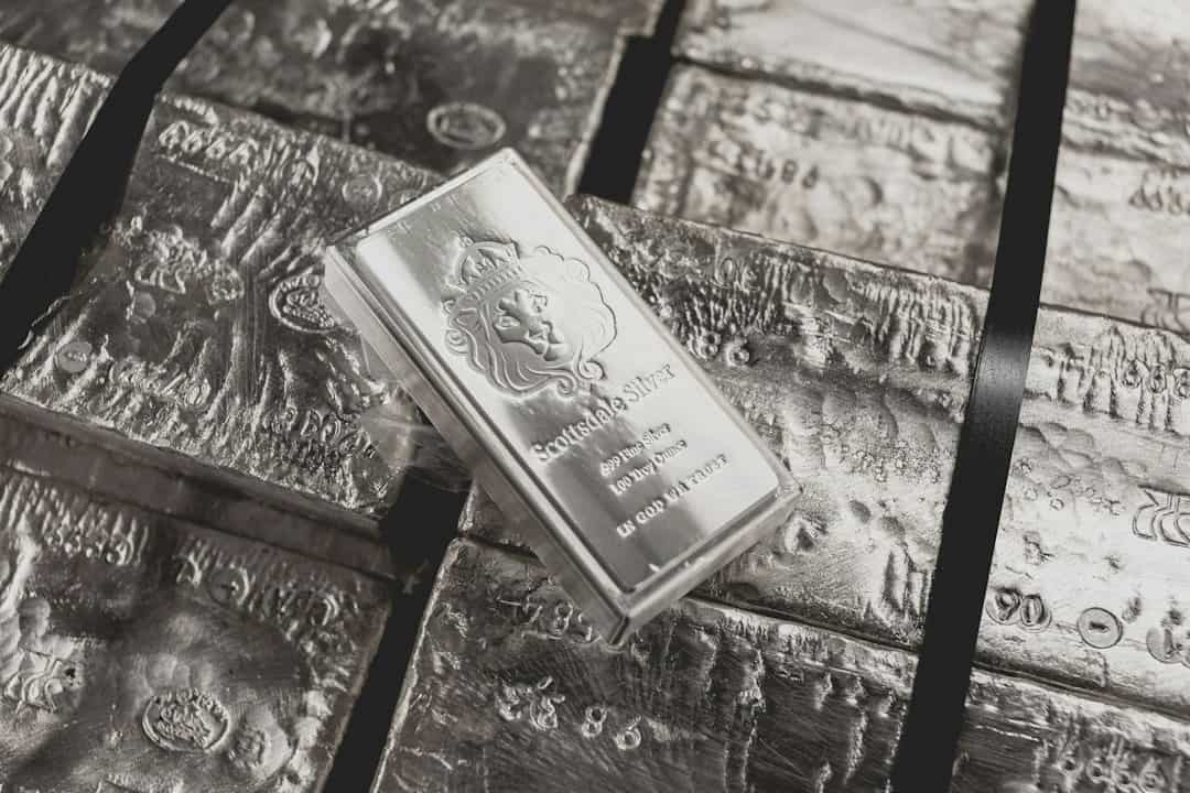 Silver bars stacked with one prominently displayed bar on top.