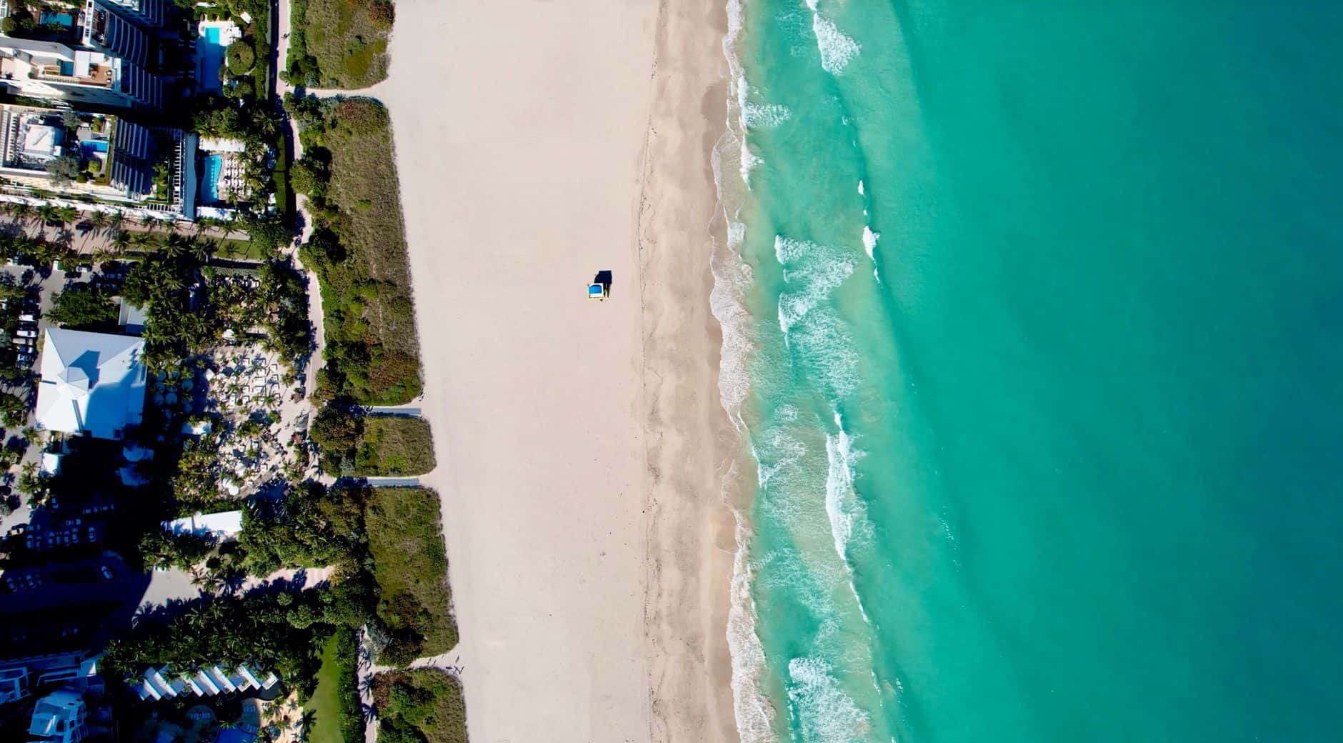 Beautiful beach with white sand and turquoise ocean waves.