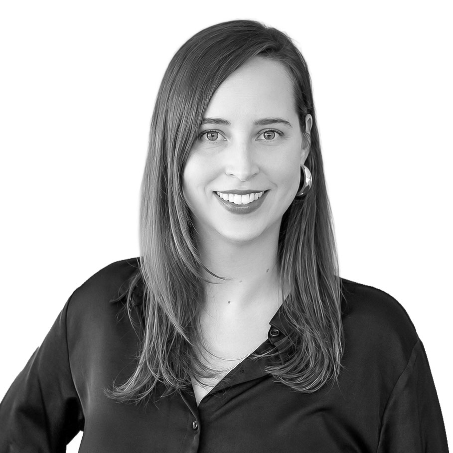 Portrait of a smiling professional woman with shoulder-length hair in a black blouse.