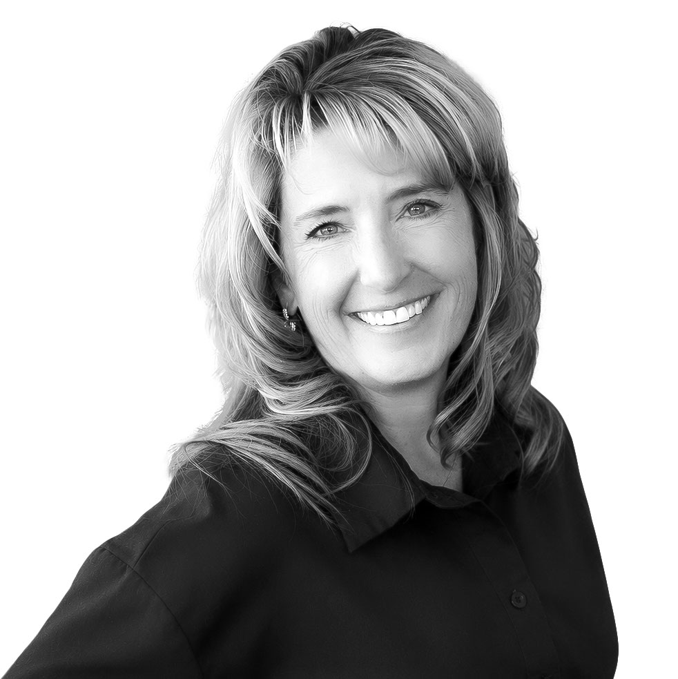 Professional woman smiling in a black blouse portrait.