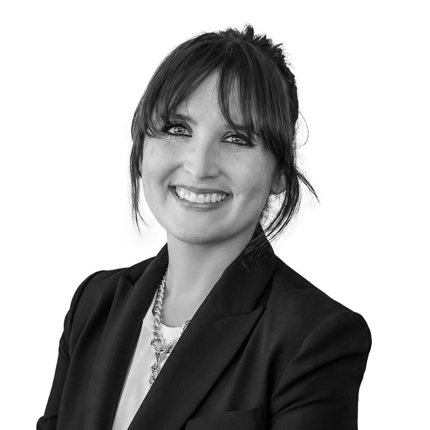 Portrait of a smiling businesswoman in a black blazer.