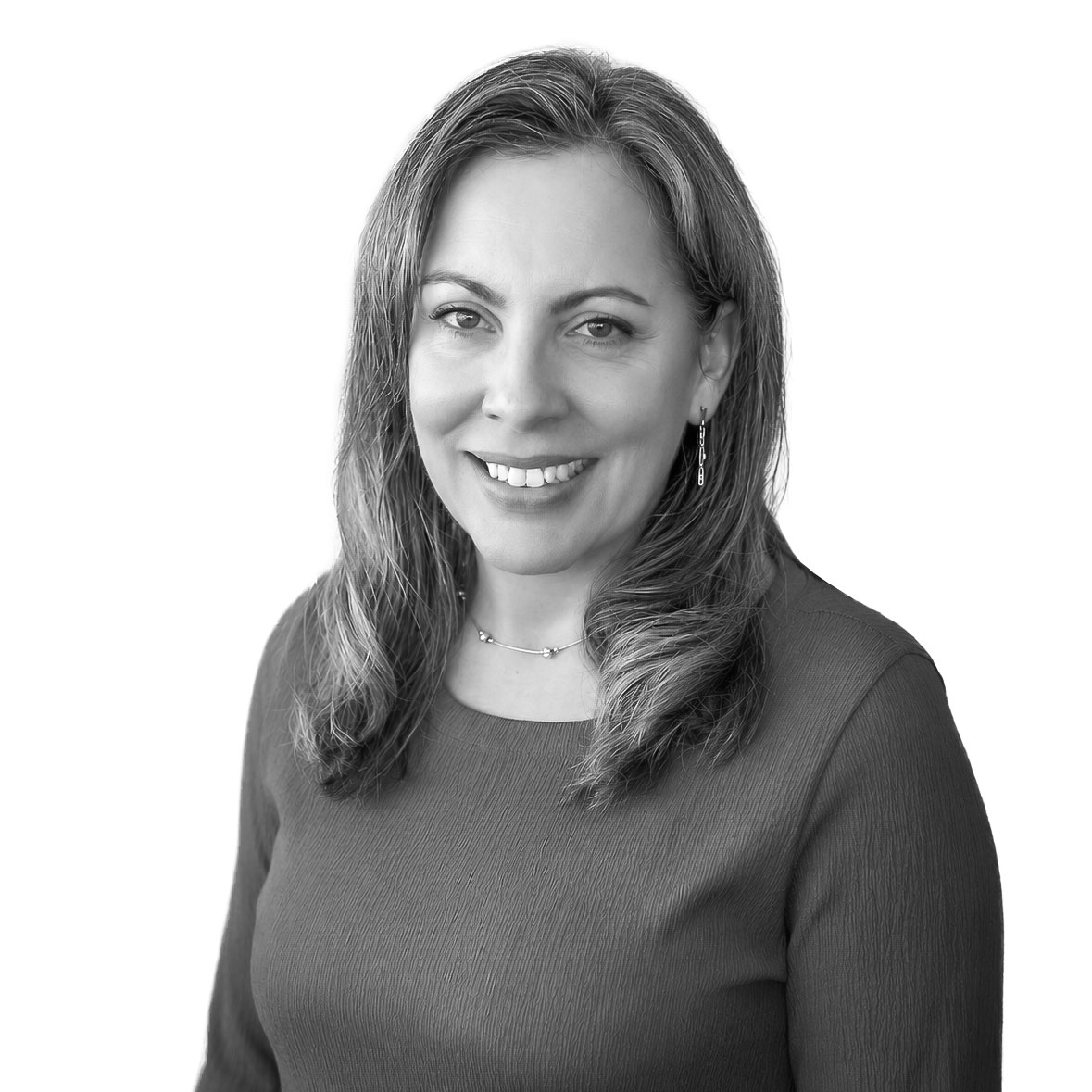 Portrait of a smiling woman in a gray dress, professional headshot.