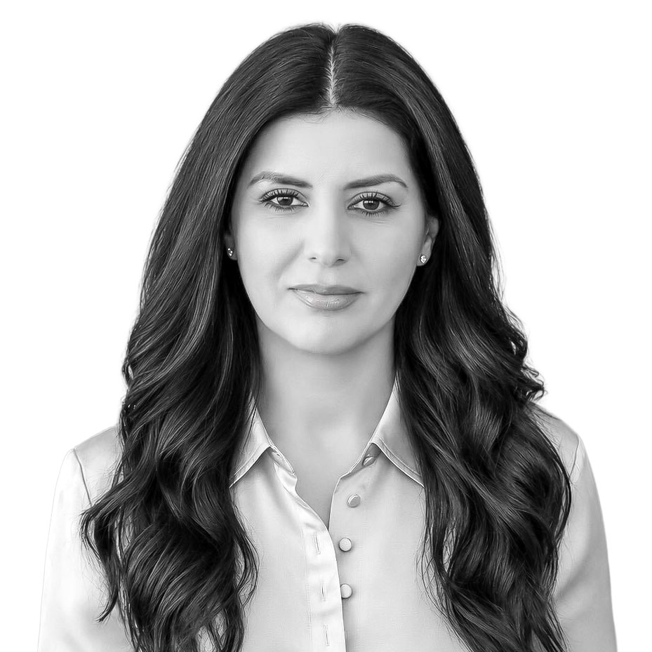 Professional business portrait of a woman with dark hair, neutral expression.
