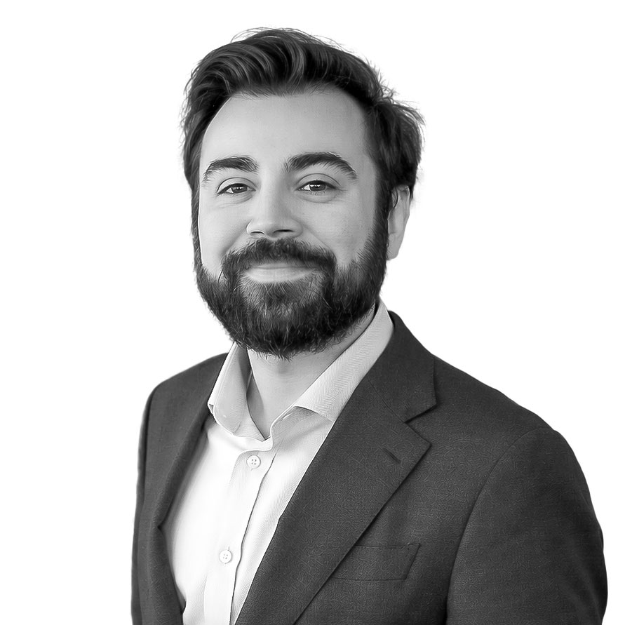 Professional man in a suit with beard smiling for Borro Company image.